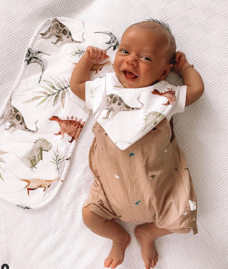 Baby smiling wearing a bib