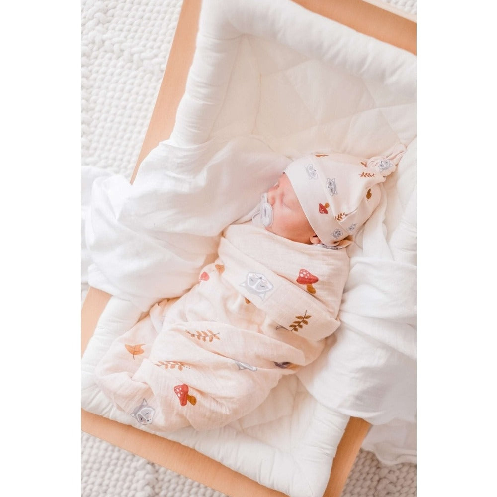 Our Raccoon Organic Swaddle Wrap &amp; Beanie is made from the finest quality cotton, light weight breathable muslin which is ultra soft, highly absorbent and quick drying. Raccoon Organic Swaddle Wrap &amp; Beanie features a playful design and are the most beautiful wraps for birth announcement outfits