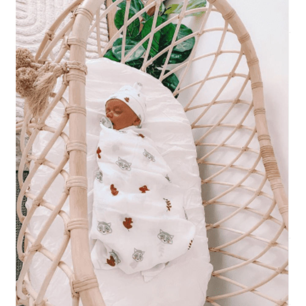 Our Raccoon White Organic Swaddle Wrap &amp; Beanie is made from the finest quality cotton, light weight breathable muslin which is ultra soft, highly absorbent and quick drying. Raccoon White Organic Swaddle Wrap &amp; Beanie features a playful design and are the most beautiful wraps for birth announcement outfits.